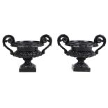 Property of a gentleman - a pair of black painted cast iron garden urns, probably early 20th