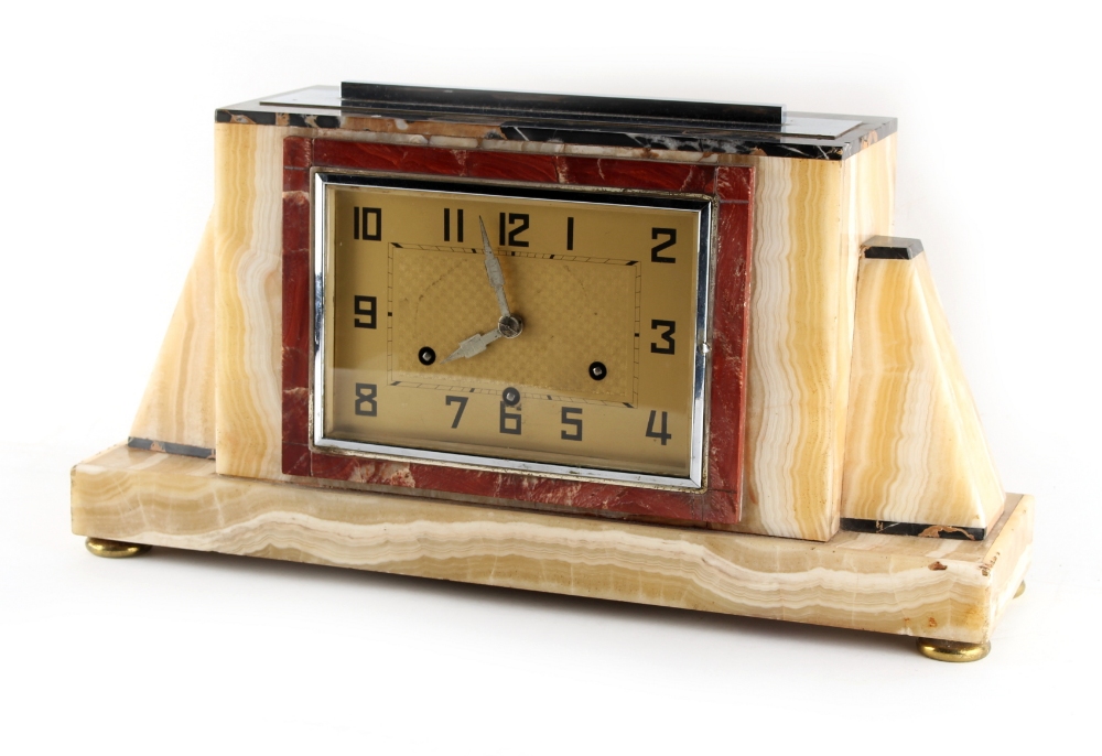 An Art Deco chrome mounted marble & onyx cased mantel clock, the 8-day movement chiming on five