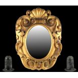 Property of a gentleman - a Victorian carved gilt framed wall mirror, 24ins. (61cms.) high; together