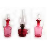 Property of a deceased estate - a pair of Victorian cranberry glass carafes with stoppers, each 9.