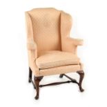 Property of a lady - a George III style wing armchair with cabriole front legs united by turned