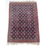 Property of a gentleman - a Persian woollen hand-knotted rug with navy field, 59 by 41ins. (150 by