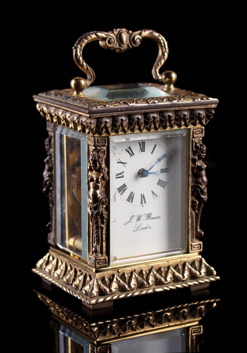 Sold on behalf of Weldmar Hospicecare Trust - a brass miniature carriage clock, with caryatid