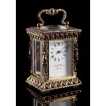 Sold on behalf of Weldmar Hospicecare Trust - a brass miniature carriage clock, with caryatid