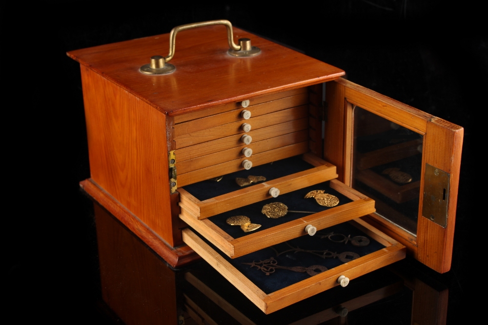 Property of a lady - a pine collector's cabinet with glazed door enclosing ten numbered drawers,