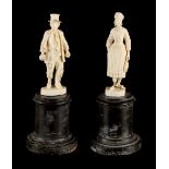 Property of a gentleman - a pair of late 19th century Continental carved ivory figures, on turned