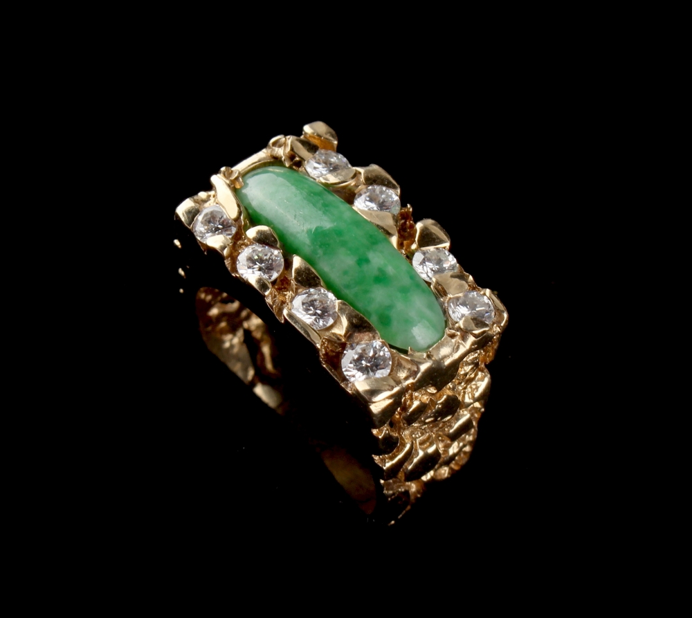 A 14ct yellow gold jadeite & diamond ring, the round ended rectangular jadeite panel flanked by