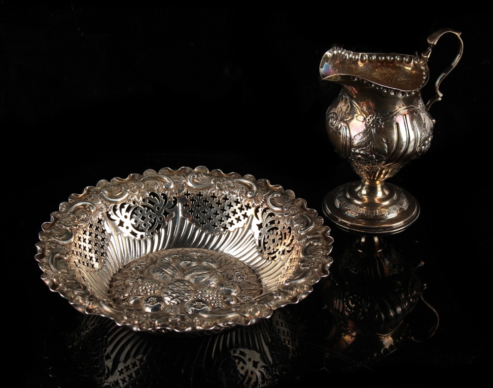 Property of a deceased estate - a Victorian helmet cream jug with floral repousse decoration,