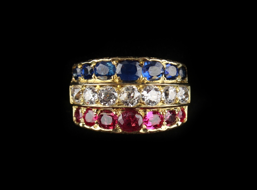 An 18ct yellow gold multi gem set ring, pave set with three rows of seven each graduated rubies,