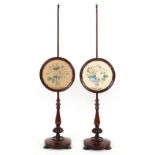 Property of a lady - a pair of early Victorian rosewood polescreens, the circular panels each with a