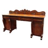 Property of a lady - a late Regency period mahogany twin pedestal sideboard, with carved low