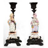 Property of a lady - a pair of candlesticks surmounted by 19th century Paris porcelain figures of an