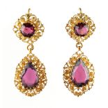 A pair of Georgian cannetille filigree yellow metal & garnet pendant earrings, each with a pear