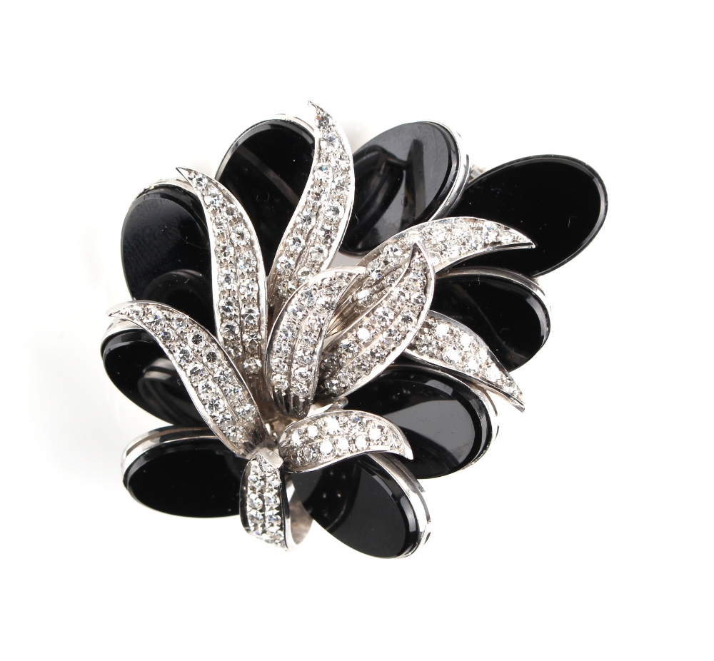 A good white gold black onyx & diamond floral brooch, probably 1970's, with black onyx oval panels &