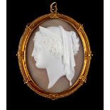 A 19th century unmarked yellow gold oval framed shell cameo depicting the head of a classical