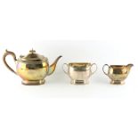 Property of a lady - a silver three piece tea-set, each with engraved crest, makers Carrington &