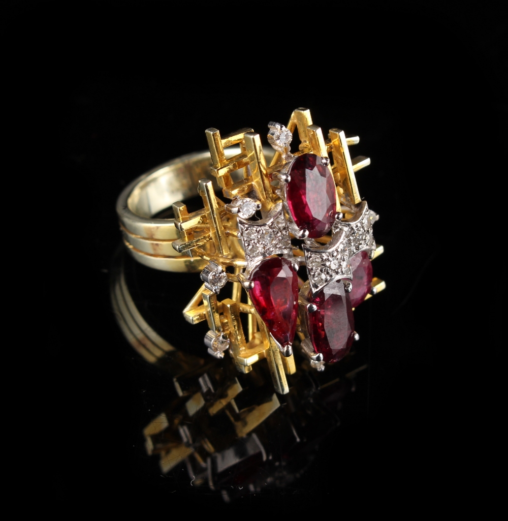 A French modernist style 14ct yellow gold ruby & diamond ring, set with four rubies of various