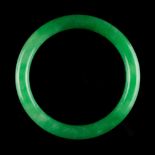 A Chinese jadeite bangle, of vivid apple green colour (see illustration).