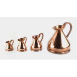 Property of a lady - a graduated set of four copper 'haystack' measuring jugs, the largest 1