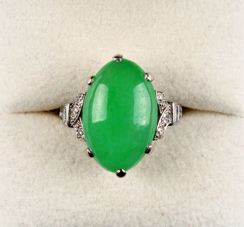 A platinum jadeite & diamond ring, the untreated oval cabochon jadeite measuring approximately 17.