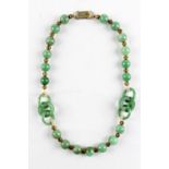 A Chinese jadeite bead & triple ring necklace, with gilt metal spacers, 16.5ins. (42cms.) long (