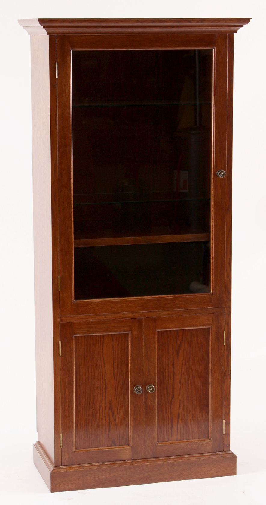 Property of a gentleman - a reproduction oak glazed single door display cabinet with two-door