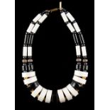 A modernist style alternating black & white ceramic link necklace, with gilt ball & paste set