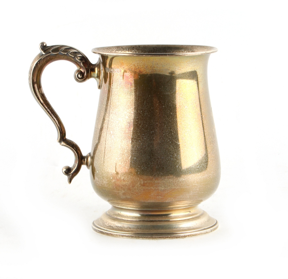 Property of a lady - a George II style silver baluster mug, with acanthus decorated scroll handle,