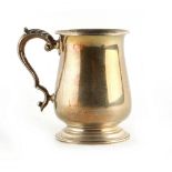Property of a lady - a George II style silver baluster mug, with acanthus decorated scroll handle,