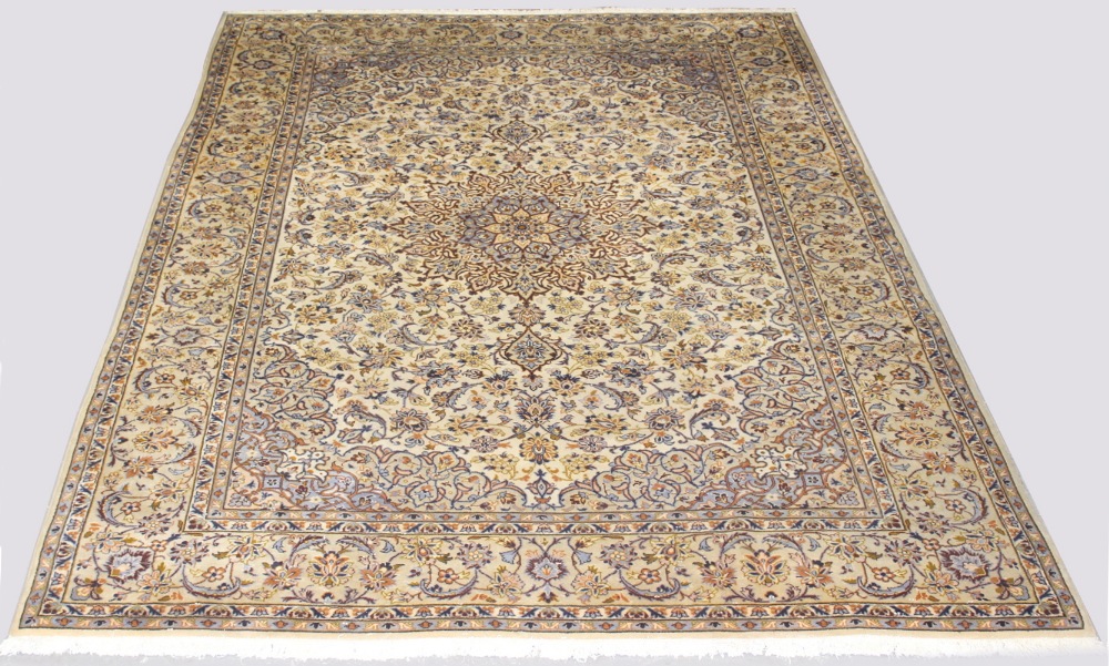 An Isfahan woollen hand-made carpet with ivory ground, 160 by 116ins. (405 by 295cms.) (see