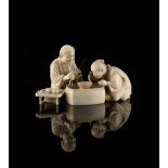 Property of a gentleman - a good Japanese carved ivory okimono depicting a man & his wife eating,