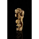A Japanese carved ivory netsuke depicting an actor holding a lion mask, Meiji period (1868-1912),