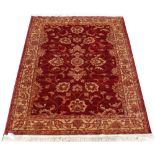 A Zeigler style rug with red ground, 75 by 53ins. (191 by 133cms.) (see illustration).