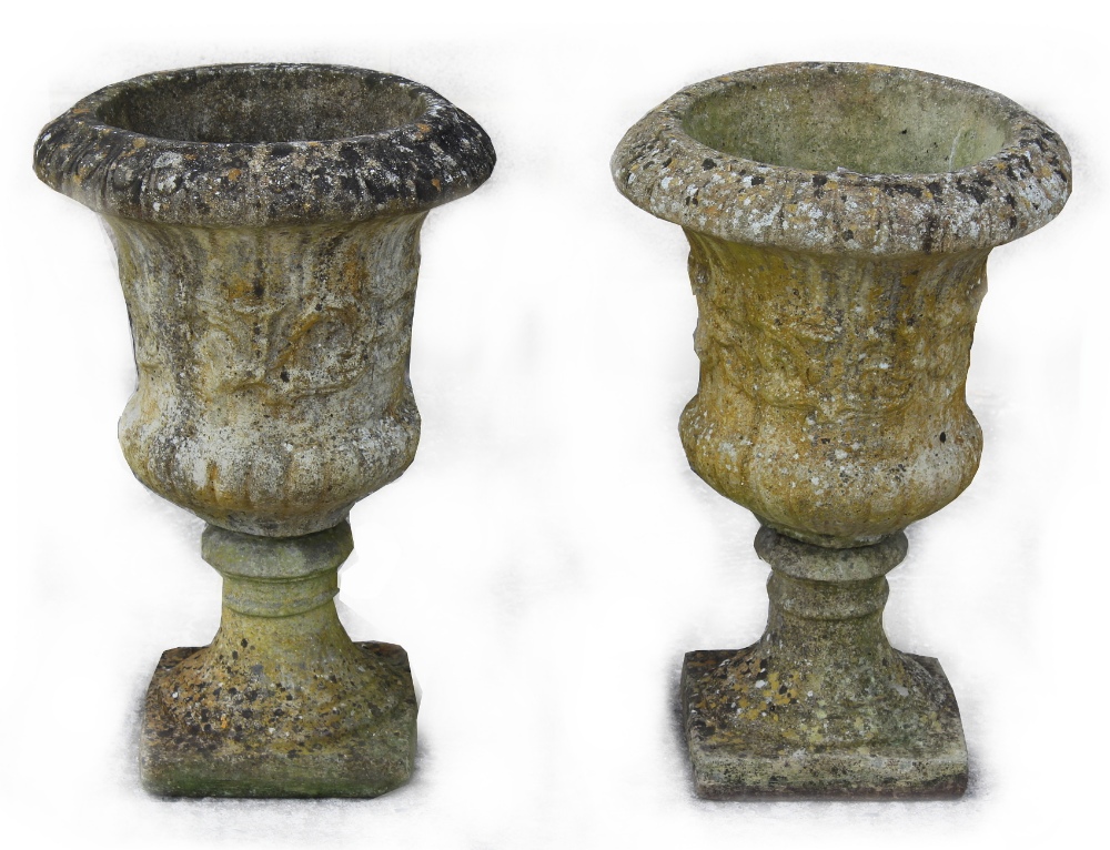 Property of a deceased estate - a pair of well weathered reconstituted stone two-part garden urns,