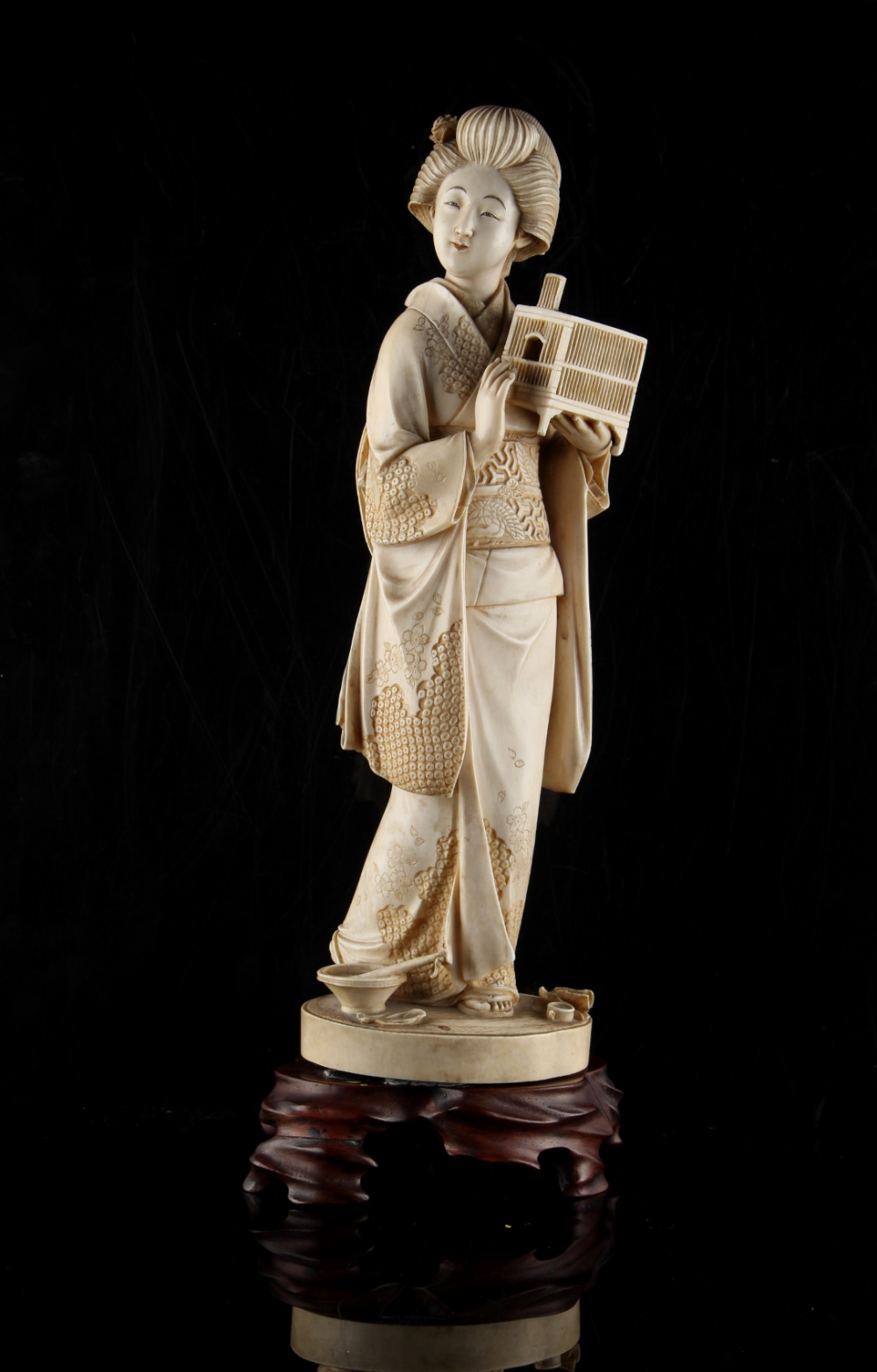 Property of a gentleman - a large Japanese carved ivory okimono depicting a bijin, Meiji period (