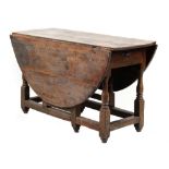 Property of a gentleman - an 18th century oak oval topped gate-leg dining table, with end drawer &