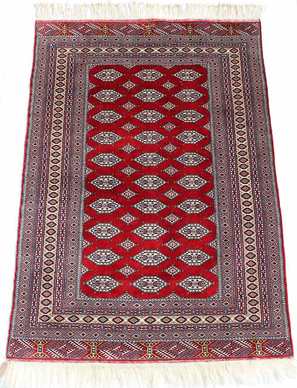 Property of a lady - a Turkoman rug with burgundy field, third quarter 20th century, condition