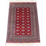 Property of a lady - a Turkoman rug with burgundy field, third quarter 20th century, condition
