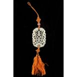 Property of a lady - a Chinese carved white jade pendant, second half 20th century, on orange