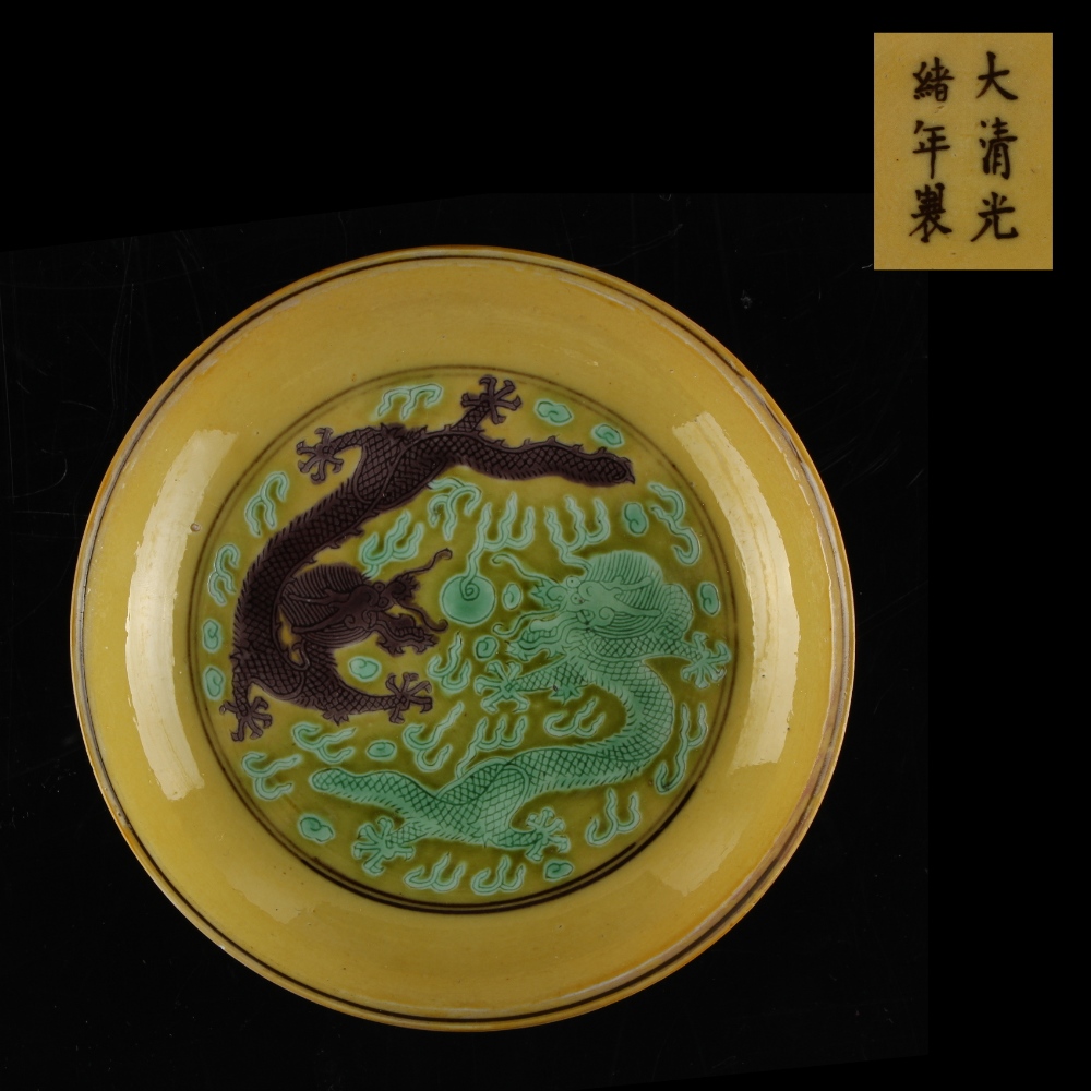 A Chinese yellow ground porcelain shallow dish with incised decoration depicting a green dragon & an