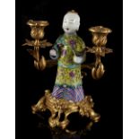 A Chinese famille rose figure of a boy, late 18th / early 19th century, modelled standing &