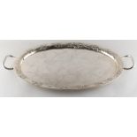 A Chinese silver two-handled oval tray, late 19th century, with engraved prunus centre within a