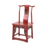 A Chinese red lacquer child's chair, 19th century, with carved panel to the back & fretwork panels