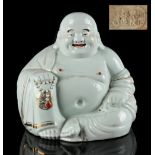 An early 20th century Chinese porcelain figure of Budai, modelled seated & decorated with gilt