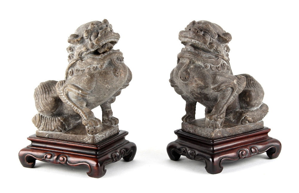 A pair of Chinese carved stone models of Buddhistic lions, probably 19th century, on later fitted