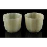 A pair of white or very pale celadon jade wine cups, of fluted octagonal form, each approximately