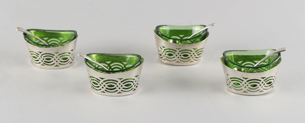 Property of a gentleman - a set of four Edwardian silver pierced oval salts, with bright green glass