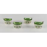 Property of a gentleman - a set of four Edwardian silver pierced oval salts, with bright green glass