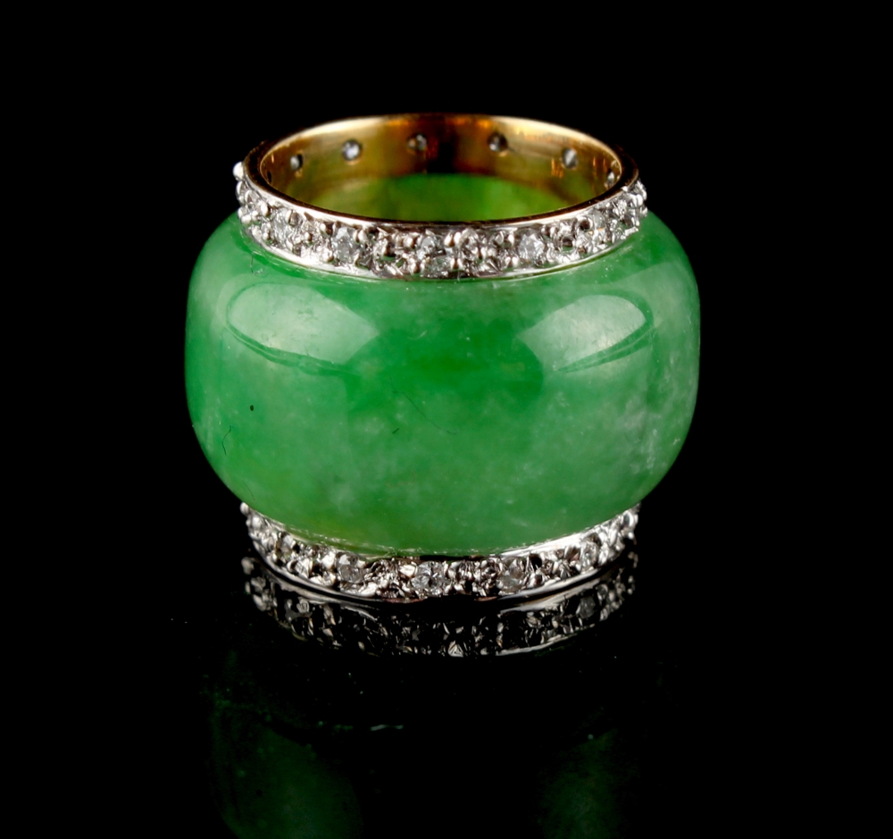 An 18ct yellow gold apple green jadeite & diamond scarf ring, 0.65ins. (1.7cms.) diameter (see