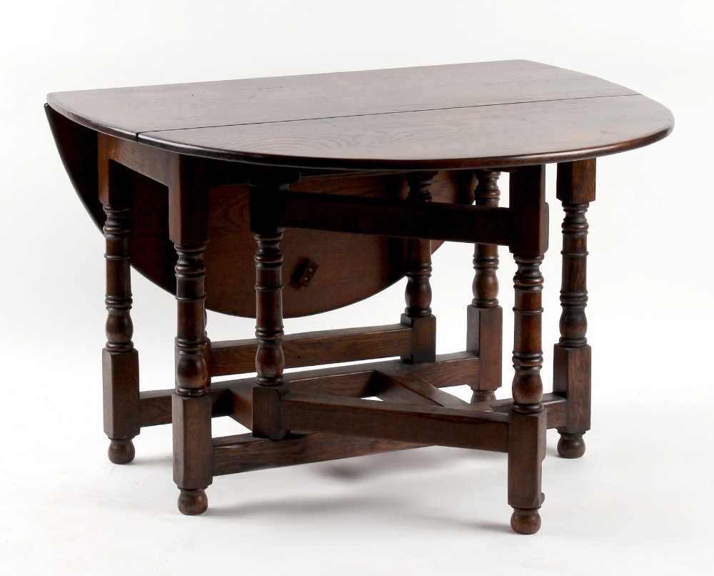 Property of a gentleman - an oak oval topped gate-leg table, with baluster turned supports, 43.